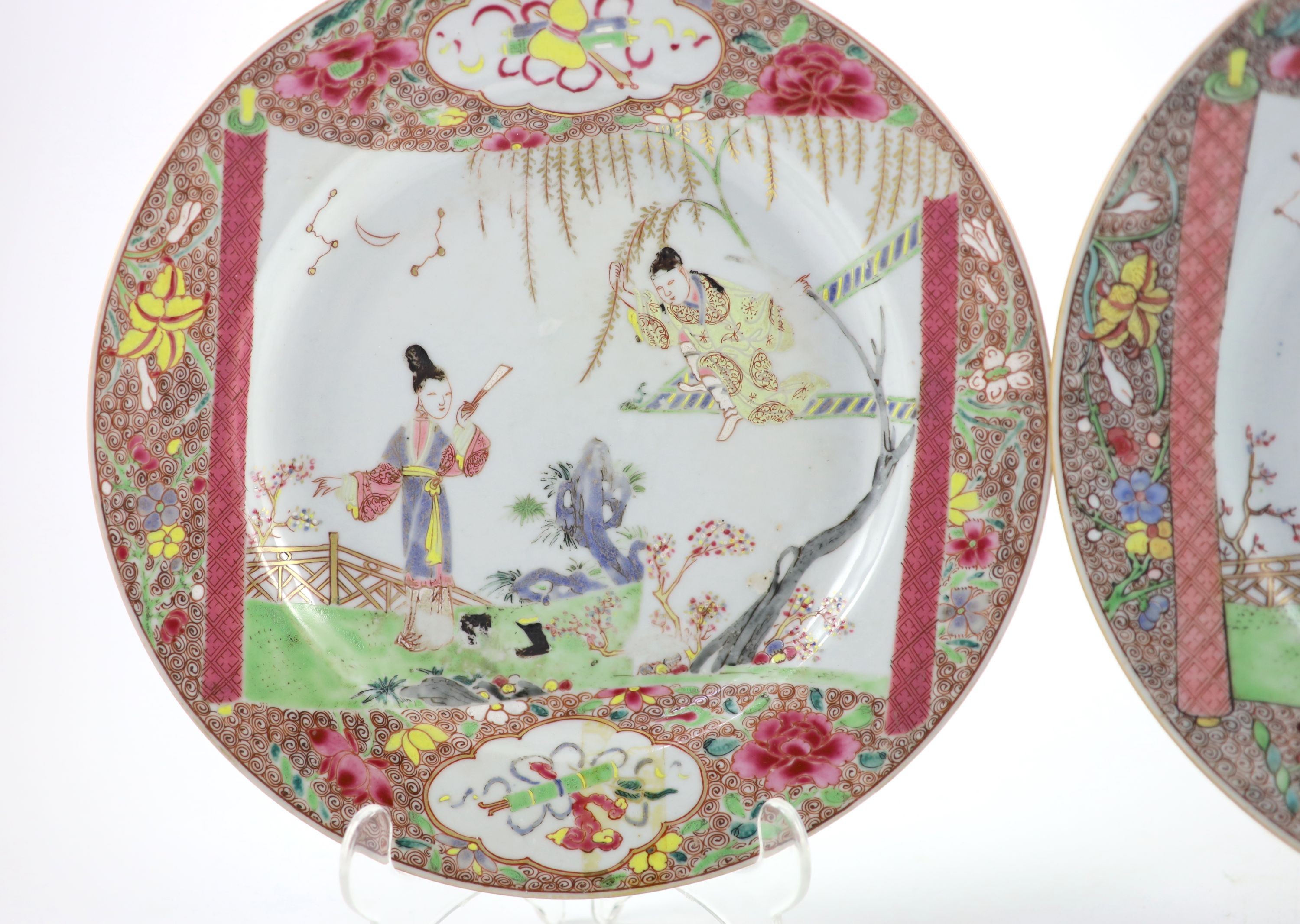 A near pair of Chinese famille rose plates, early Qianlong period, 23.3 and 22.7cm diameter